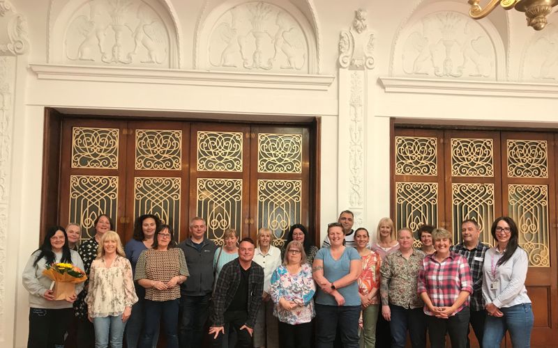 A group of foster carers smiling and posing