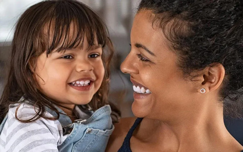 A foster carer and child smiling.