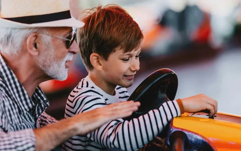 A man and a boy on a go-kart.